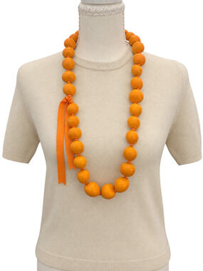 Bold chunky statement necklace featuring oversized irregular orange beads